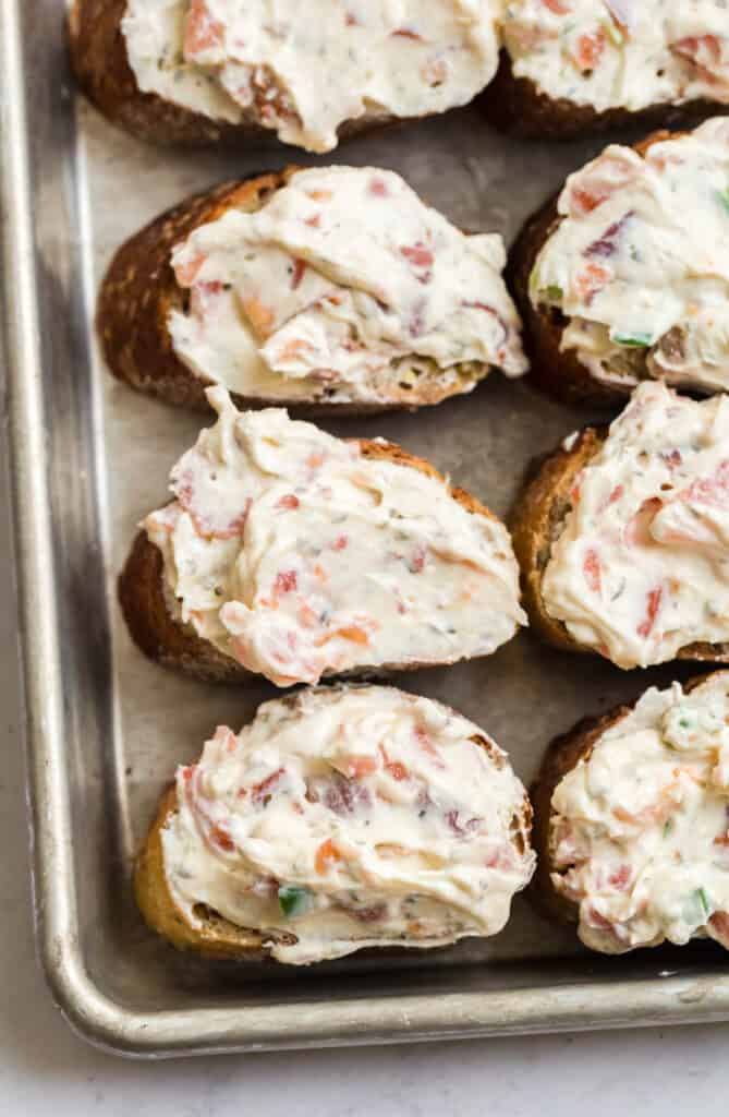sliced baguette topped with a creamy bruschetta