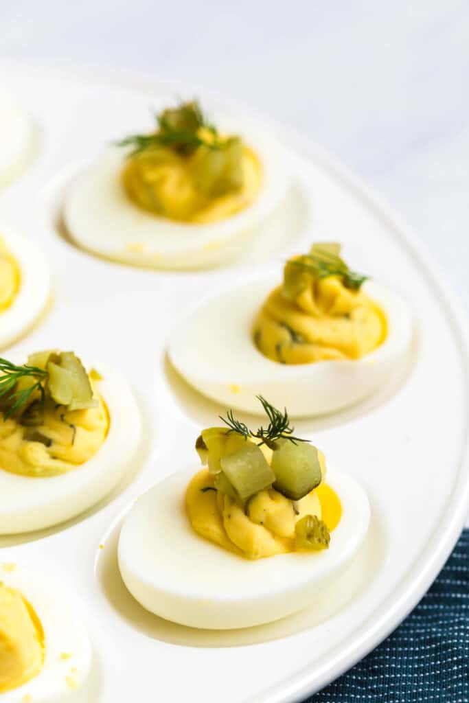 dill pickle deviled eggs topped with fresh dill and diced dill pickles
