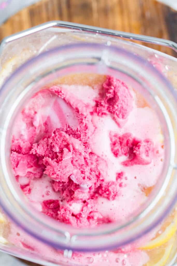 adding raspberry sorbet to a pink punch