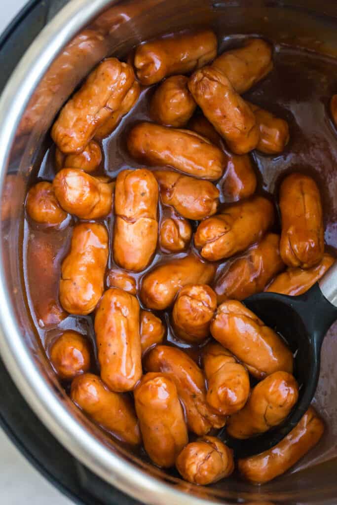cooked lil smokies surrounded with bbq sauce in an Instant Pot