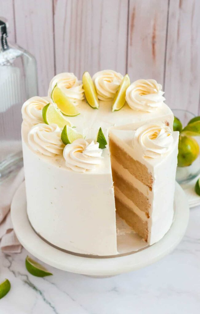 3 layer margarita cake with a slice being taken out