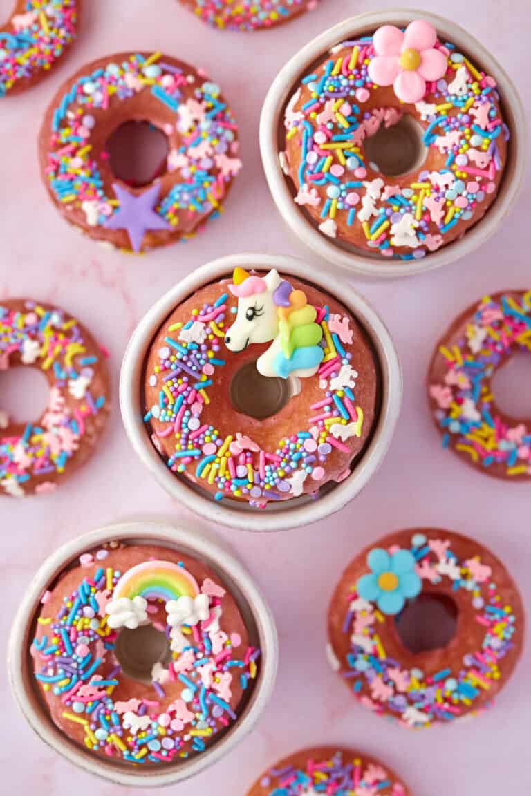 cake mix donuts with unicorn sprinkles on a pink background