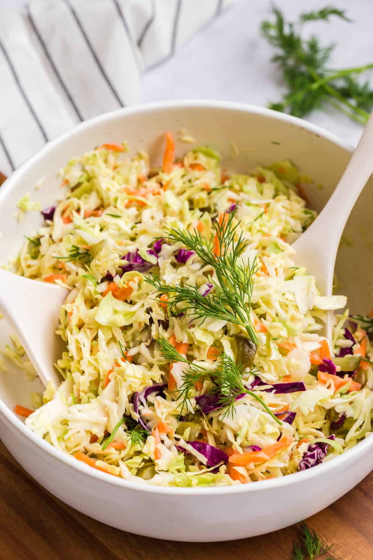 dill pickle slaw in a white mixing bowl