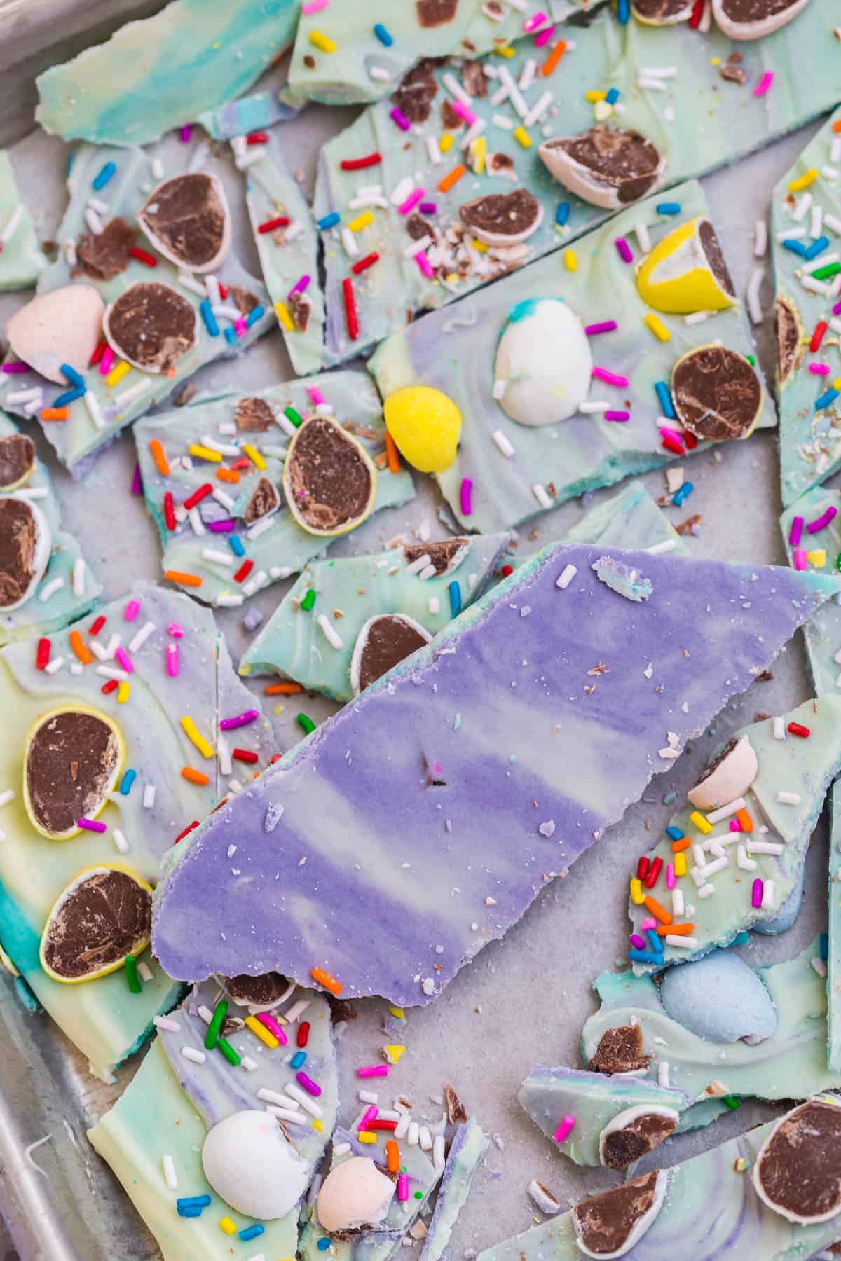 underside of white chocolate bark colored with purple and blue