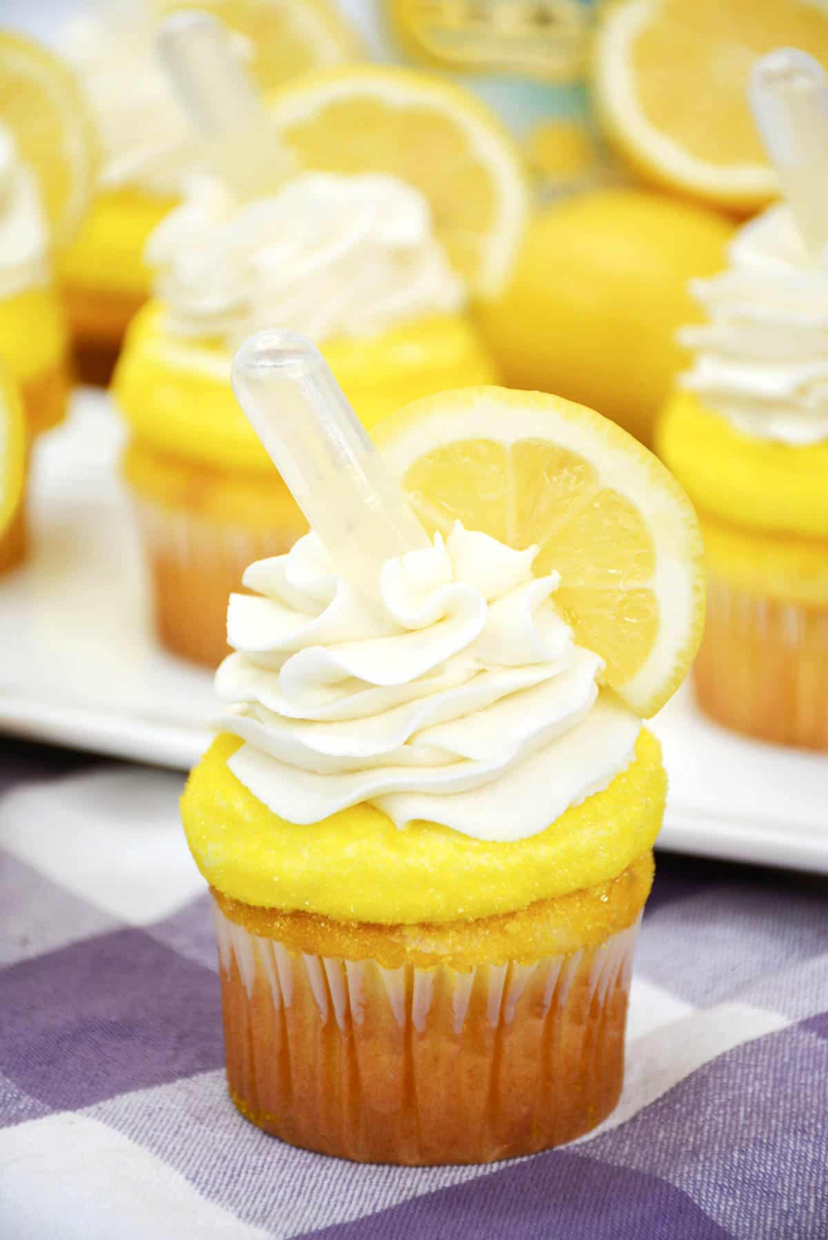 lemon cupcakes with a lemon vodka pipette on top